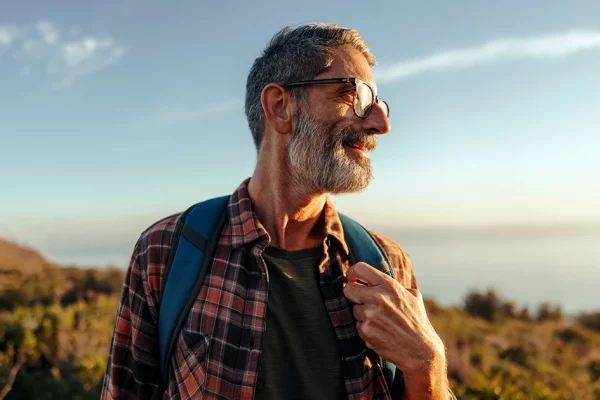 Man smiling while on a hike.