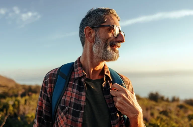 Man smiling while on a hike.