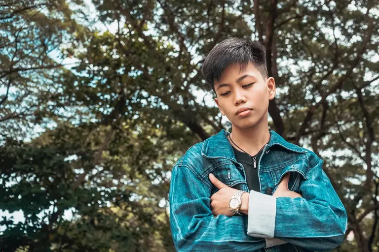 Young person in denim jacket in deep thought.